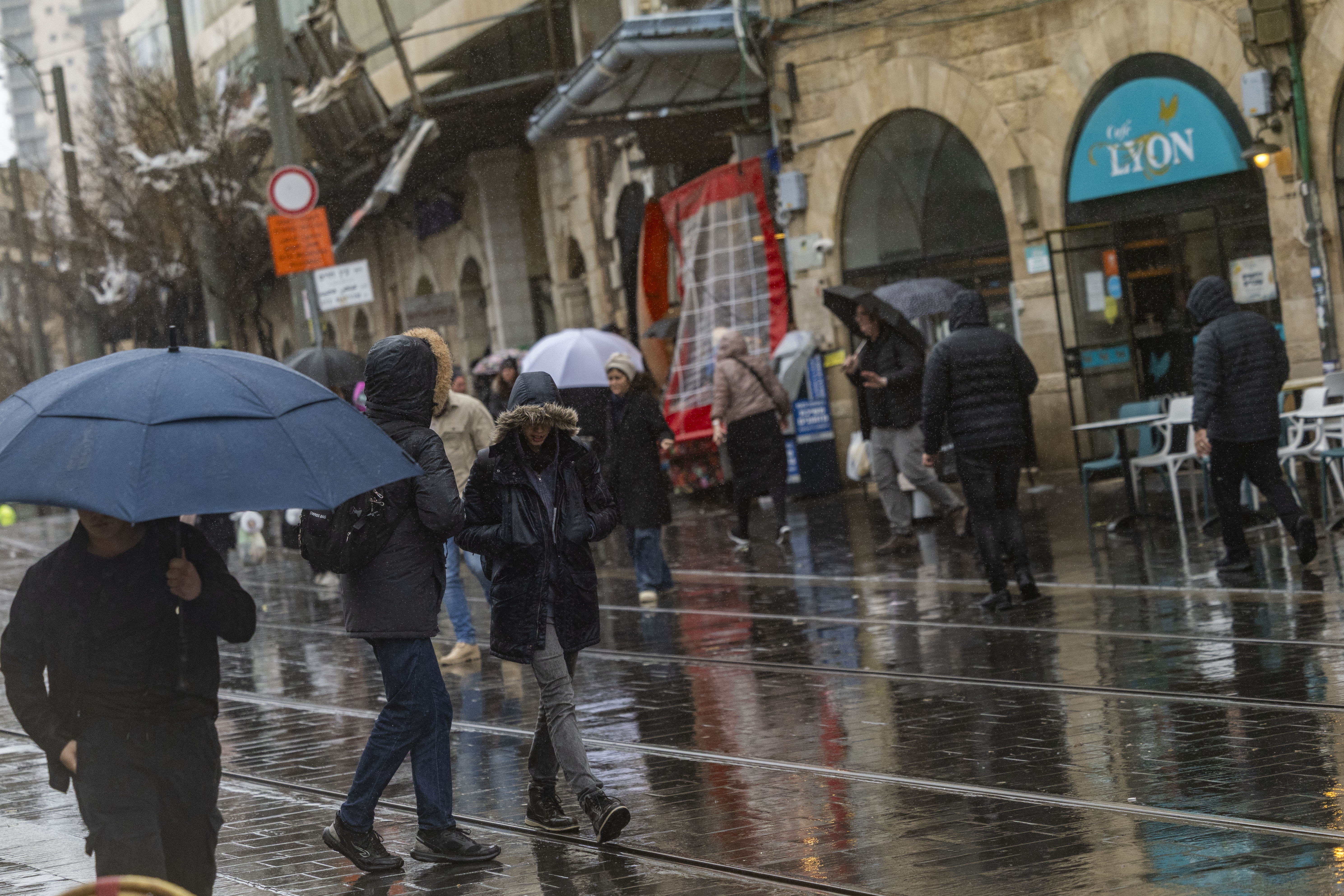 Israelis walk in the rain, Jeursalem, January 9, 2026