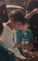 DJ Khaled signs fan's tzitzit