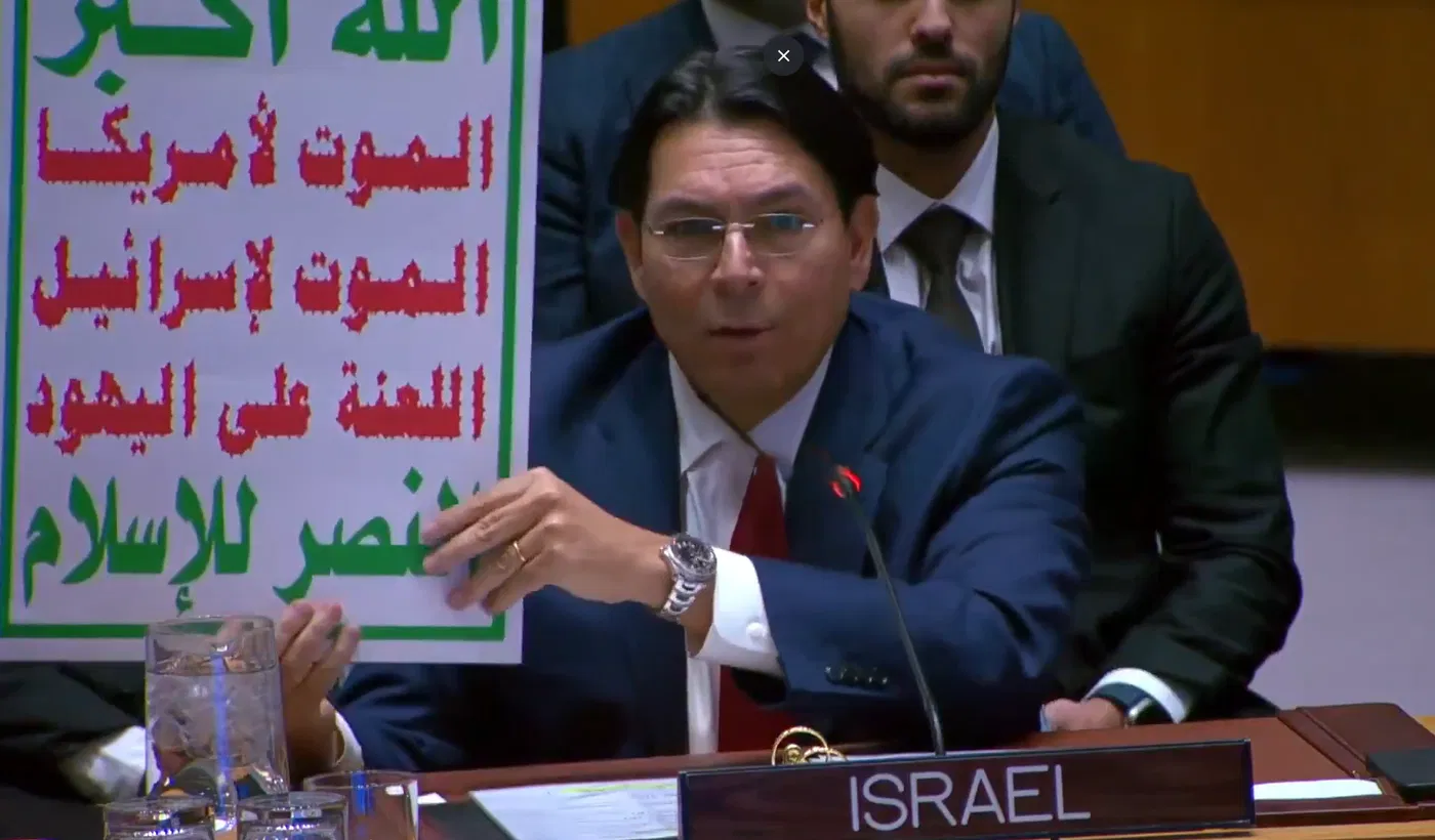 Danny Danon holds up poster of Houthi's threats against Israel