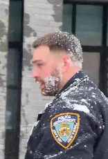 NYPD officer hit by snowballs