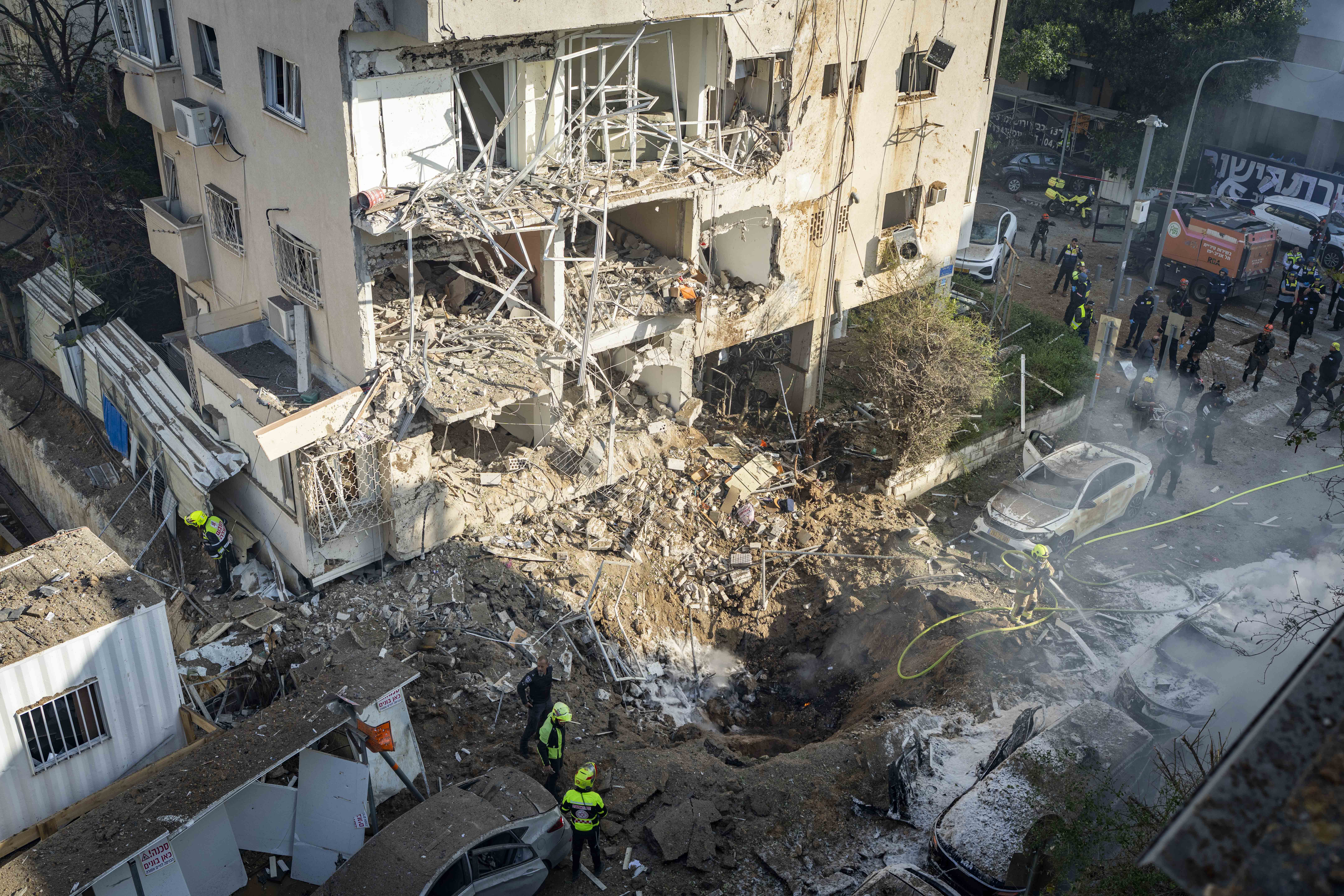Israeli security and rescue forces at the scene where a missile fired from Iran toward Israel caused damage in Tel Aviv, March 24, 2026.