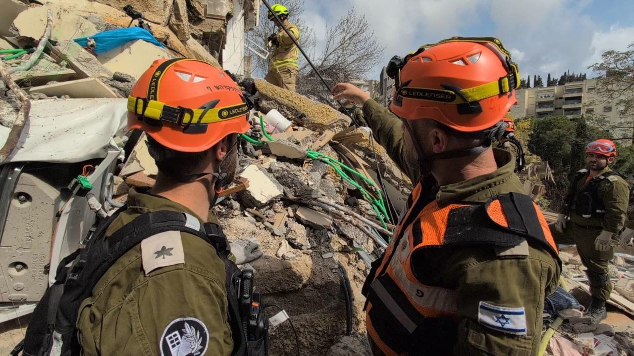 Searching for trapped people within the rubble after Iranian missile hits Haifa building