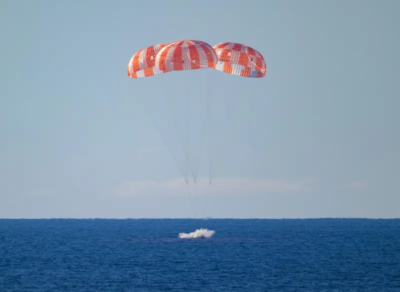 The Orion capsule entering the water upon returning to Earth.