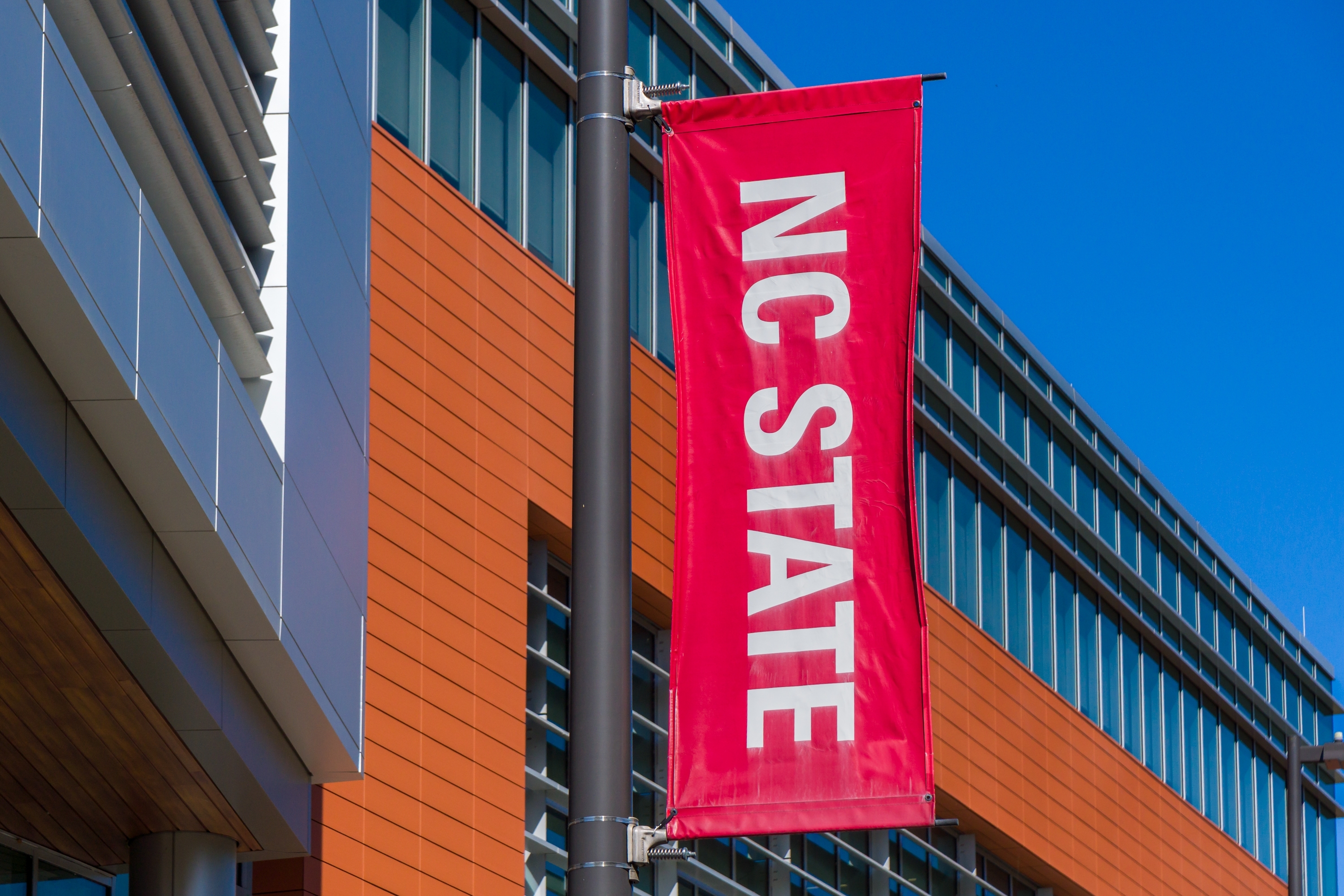 An NC State banner flying on the university's Raleigh campus.