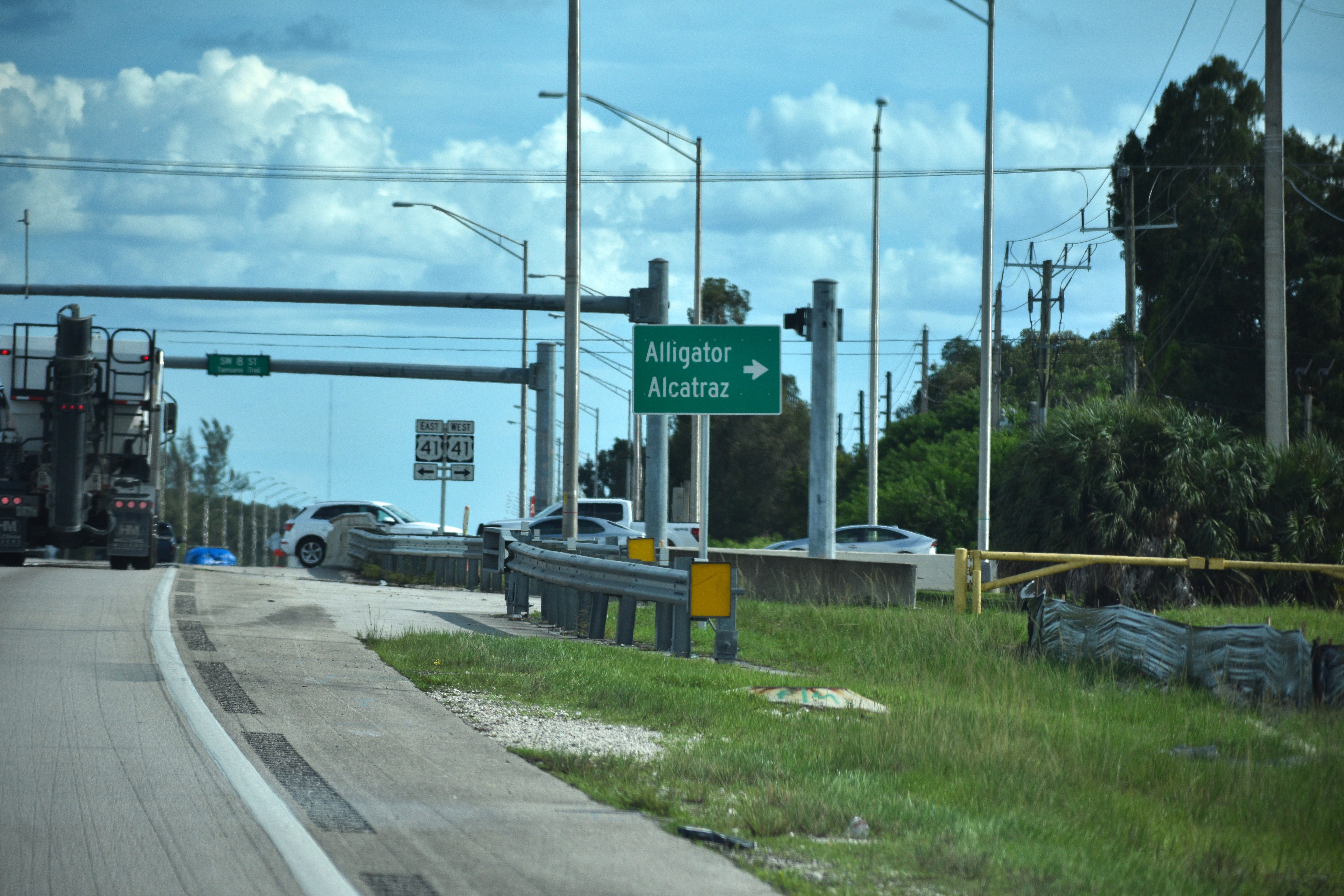 A road sign directing drivers to the immigrant detention center known as "Alligator Alcatraz."