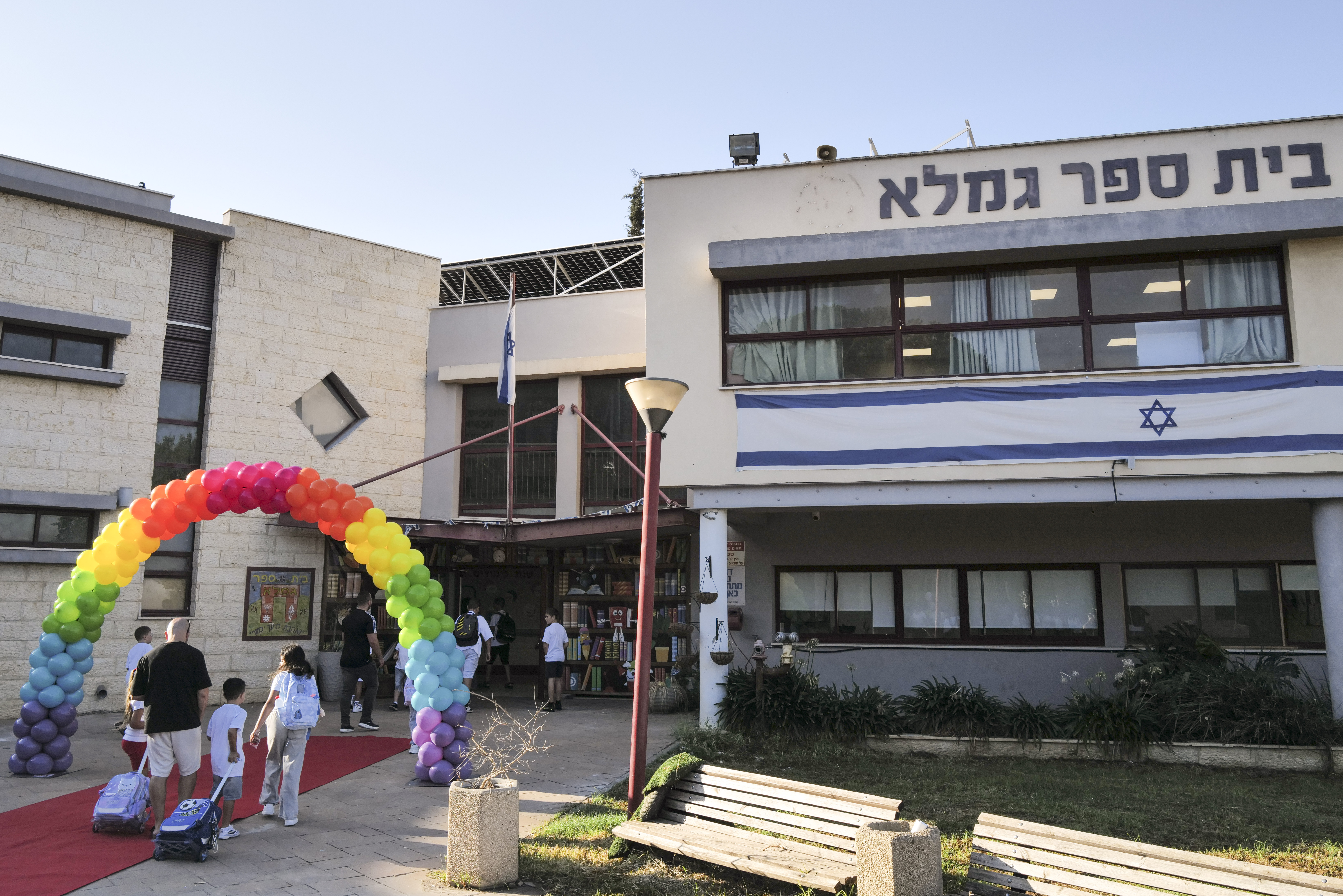 Children arrive to their first day of school at the Gamla School in the northern Israeli town of Katzrin, on September 1, 2025.
