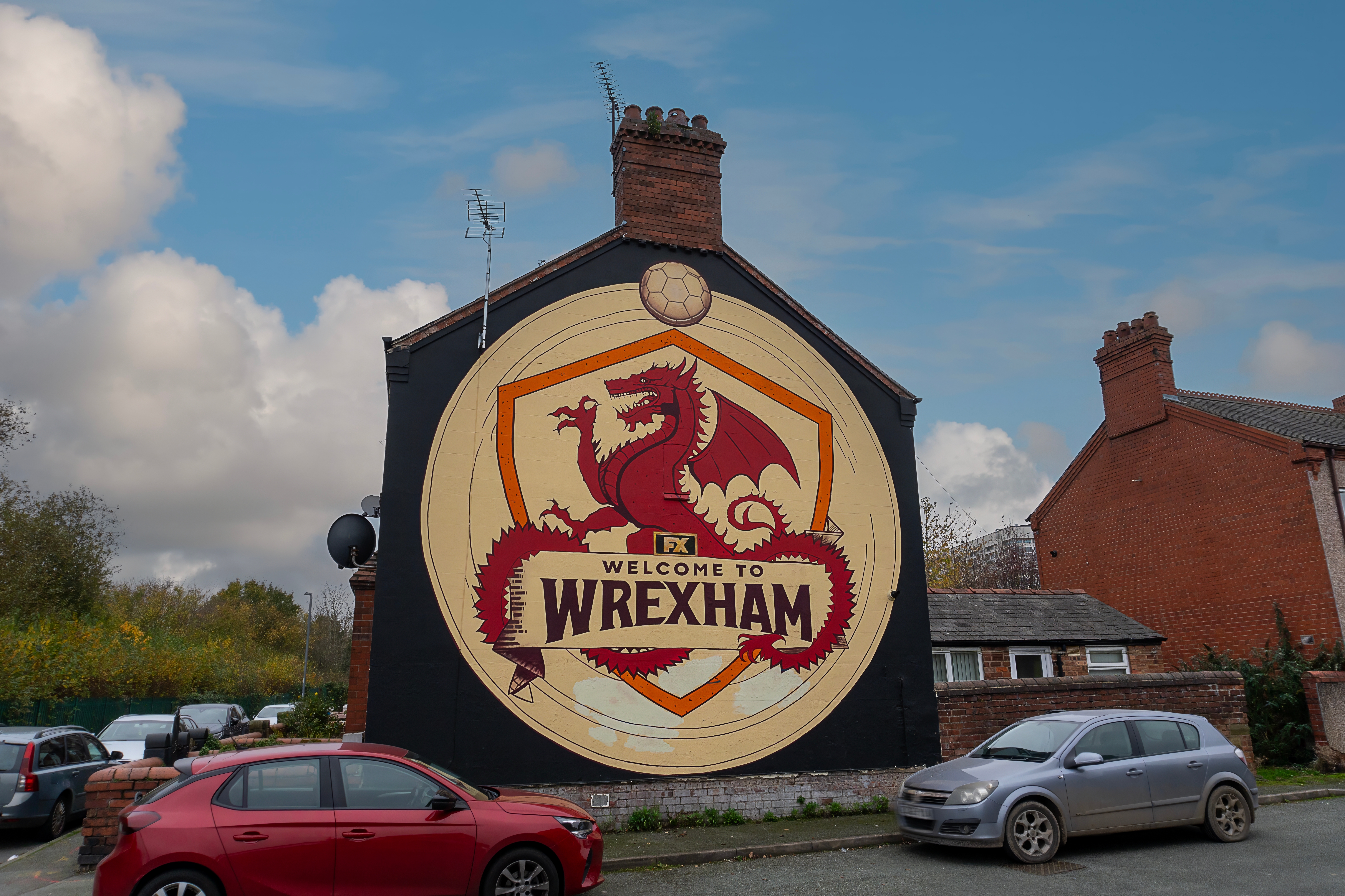 Wrexham, Wales - A "Welcome to Wrexham" mural on the exterior wall of a row of houses,