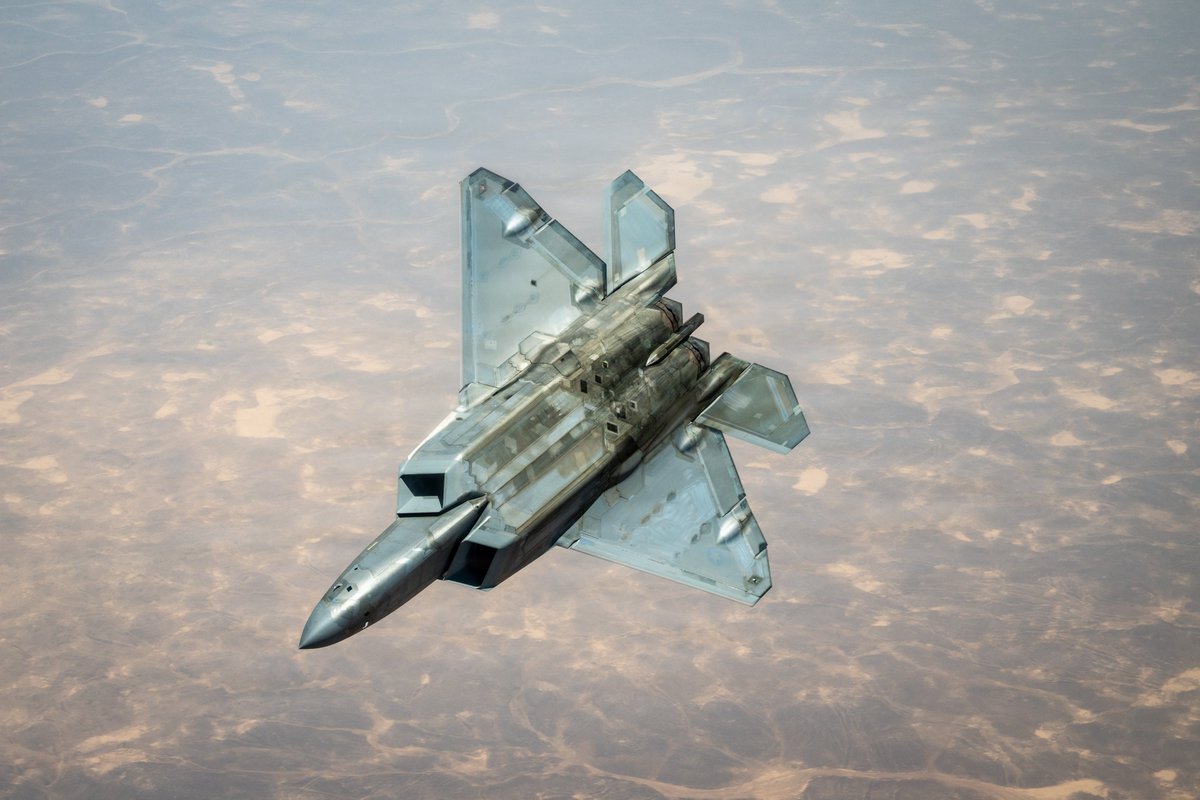 A U.S. Air Force F-22 Raptor stealth fighter is refueled by a KC-135 Statotanker while flying over the Middle East.