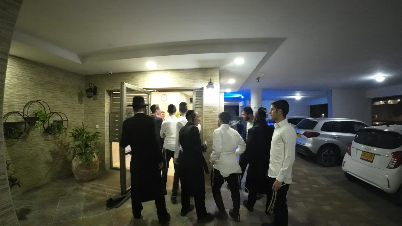 Activists demonstrate outside the private home of a military prison officer