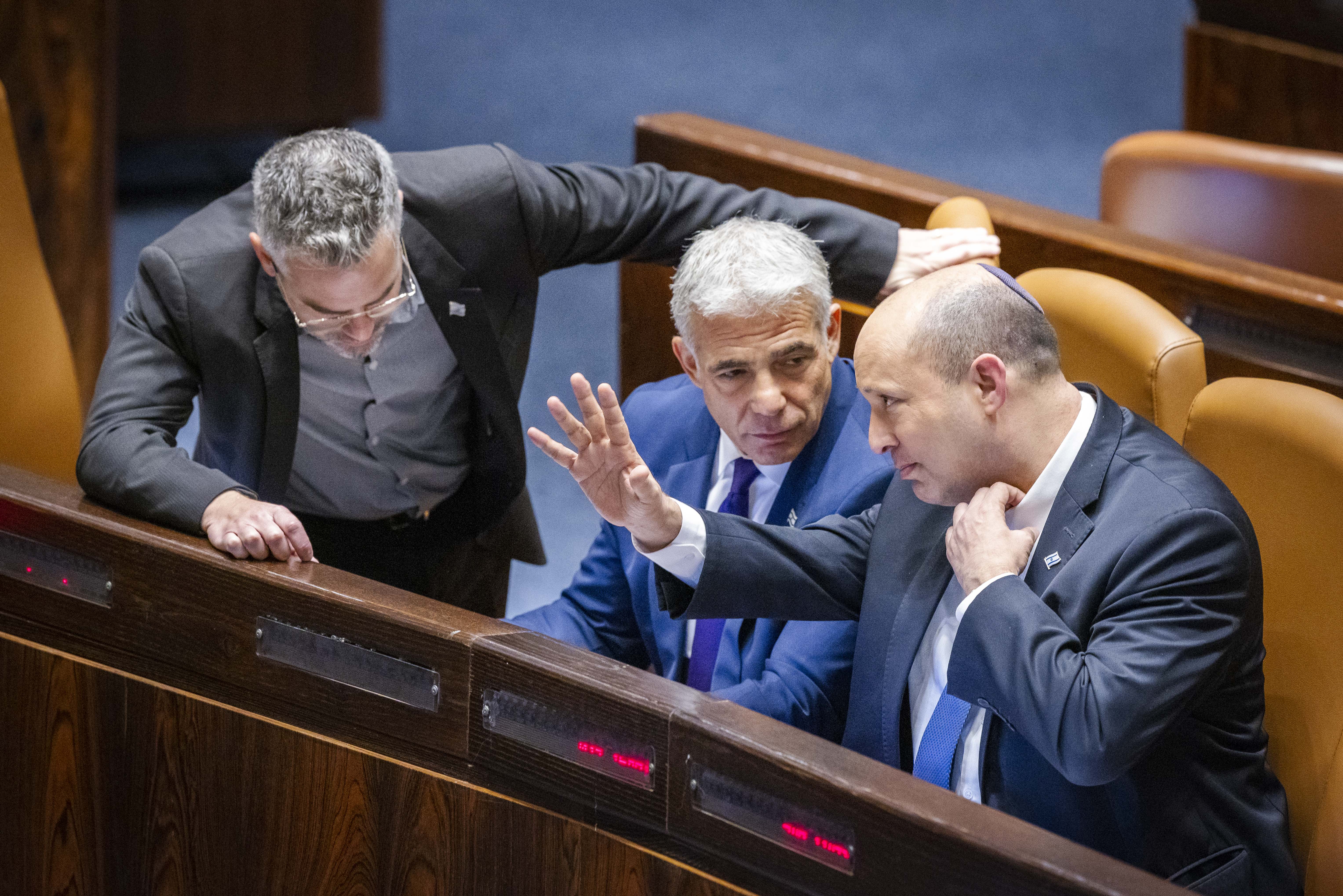 Israeli prime minister Naftali Bennett, Minister of Foreign Affairs Yair Lapid and MK Boaz Toporovsky during a discussion and a vote on a bill to dissolve the Knesset, at the assembly hall of the Israeli parliament, in Jerusalem, on June 22, 2022.