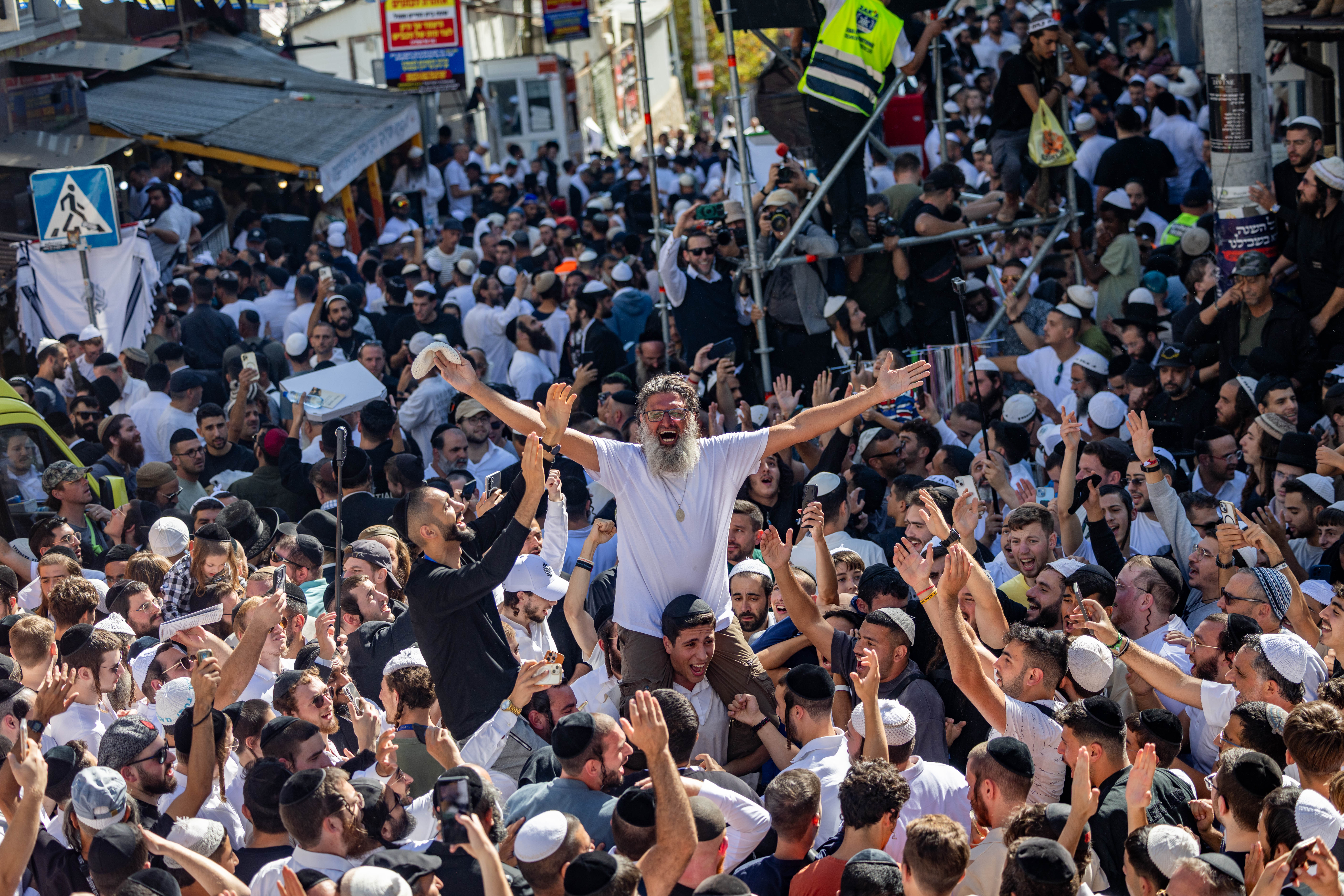 Jewish men in the street during Tikkun HaKlali near the tomb of Rabbi Nachman of Breslov in Uman, on eve of the Jewish holiday of Rosh Hashanah, September 22, 2025.
