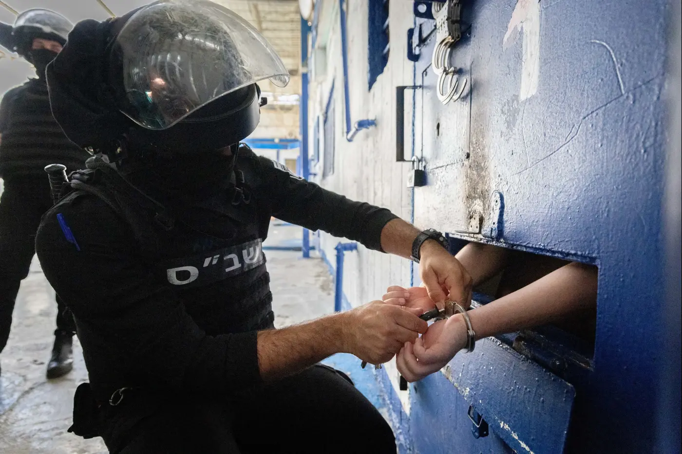 Israel Prison Service guards with prisoners