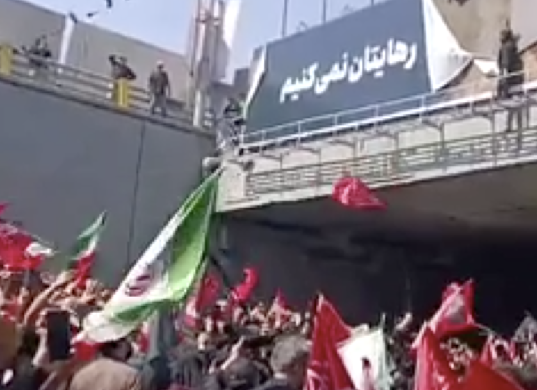 Fury in Tehran: Enraged Crowd Tears Down Trump Billboard at Khamenei Funeral