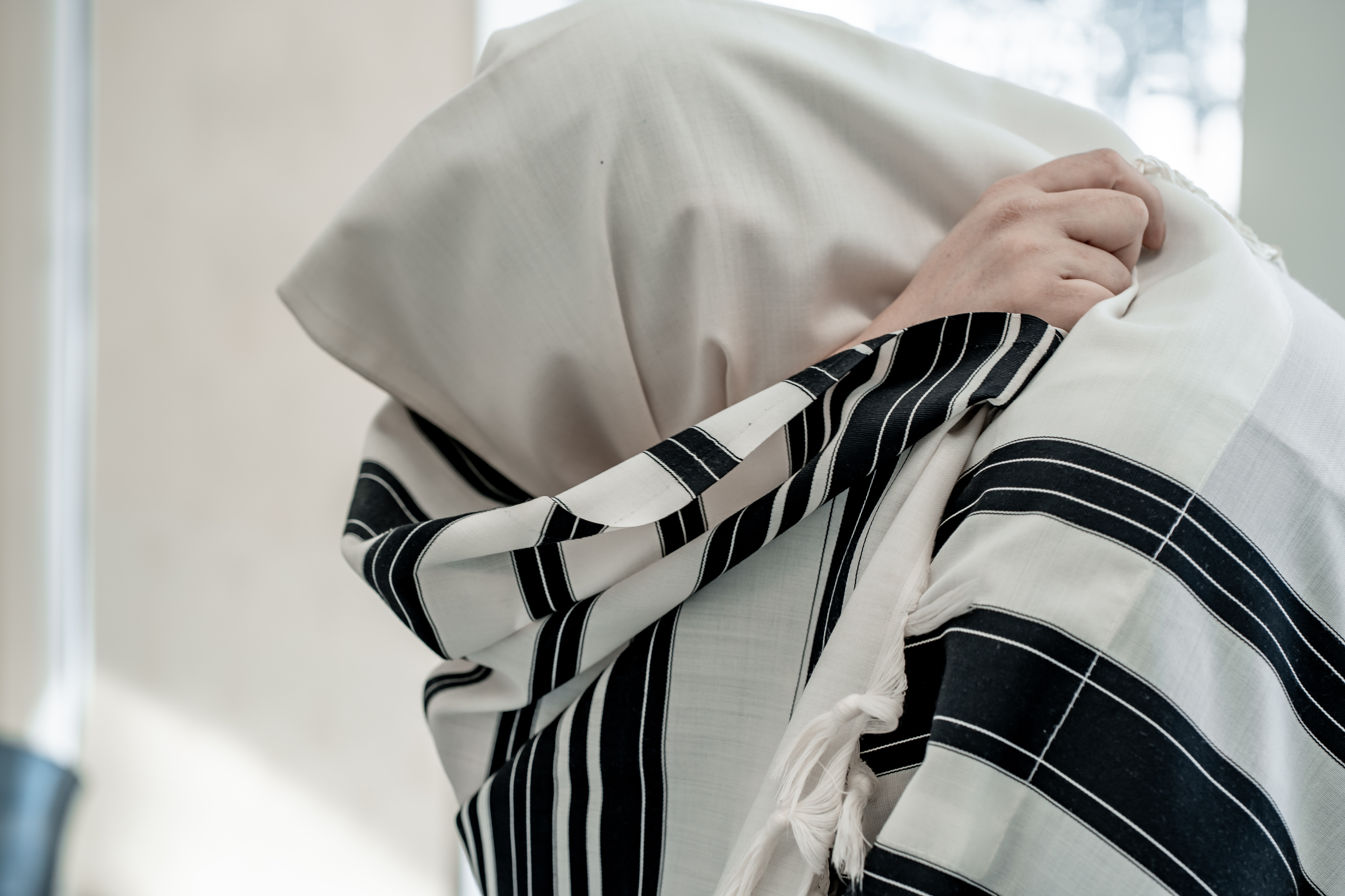 Jewish man praying in a tallit