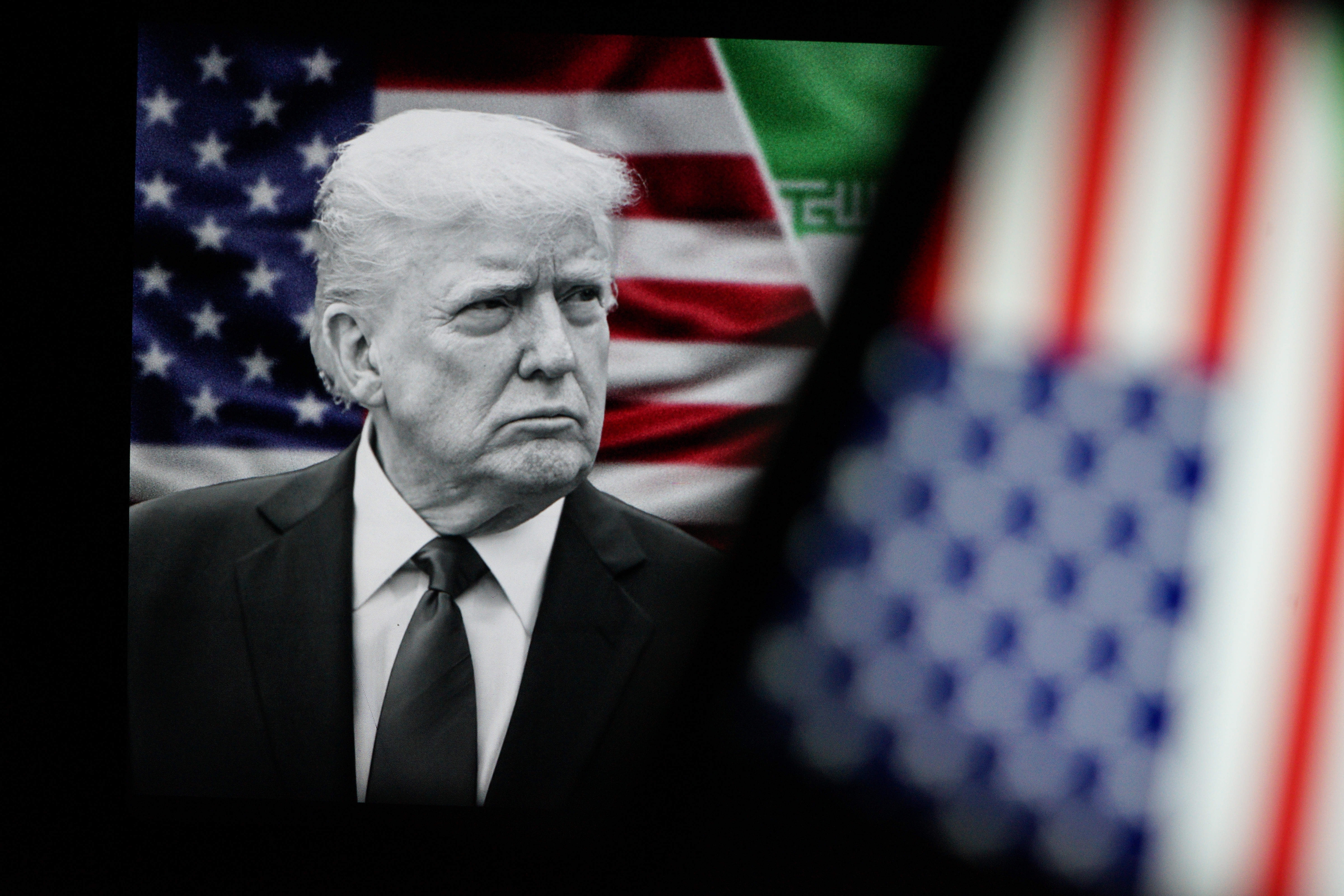 Trump on a background of US And Iranian flags