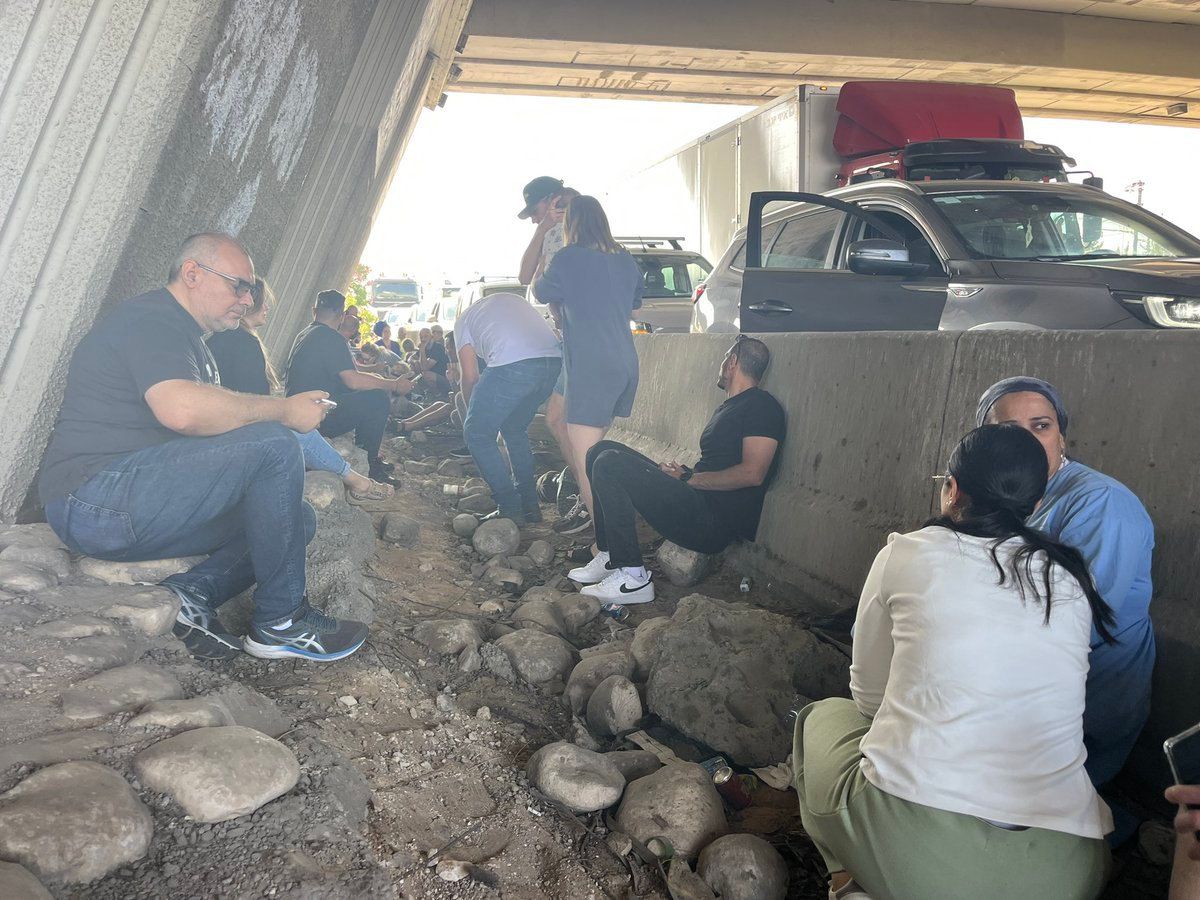 On the way to reserve service, IDF soldiers seek shelter during an air raid siren 