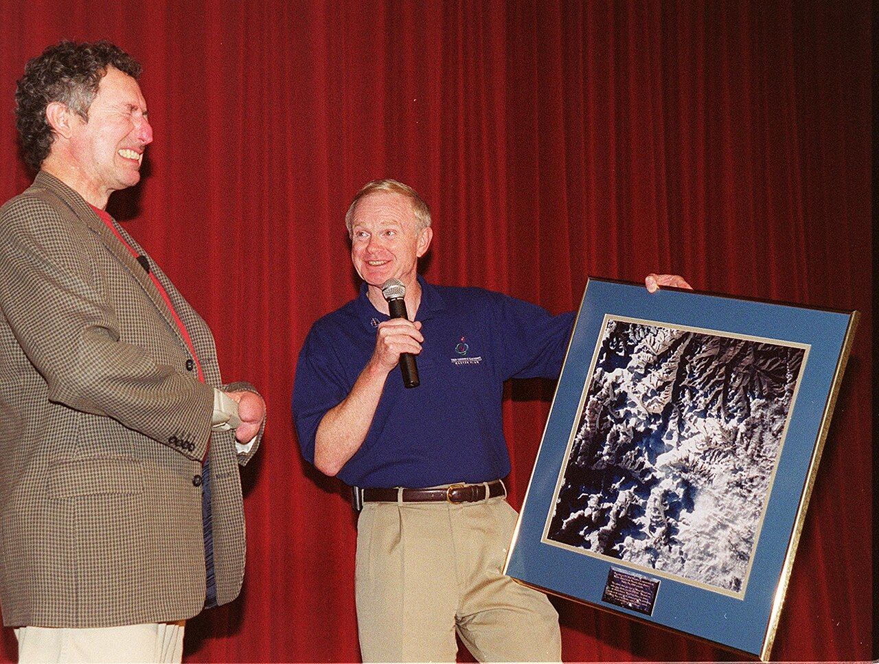 During KSC's Health and Safety Day, keynote speaker Dr Beck Weathers grimaces at the satellite image of Mount Everest displayed by centre director Roy Bridges.