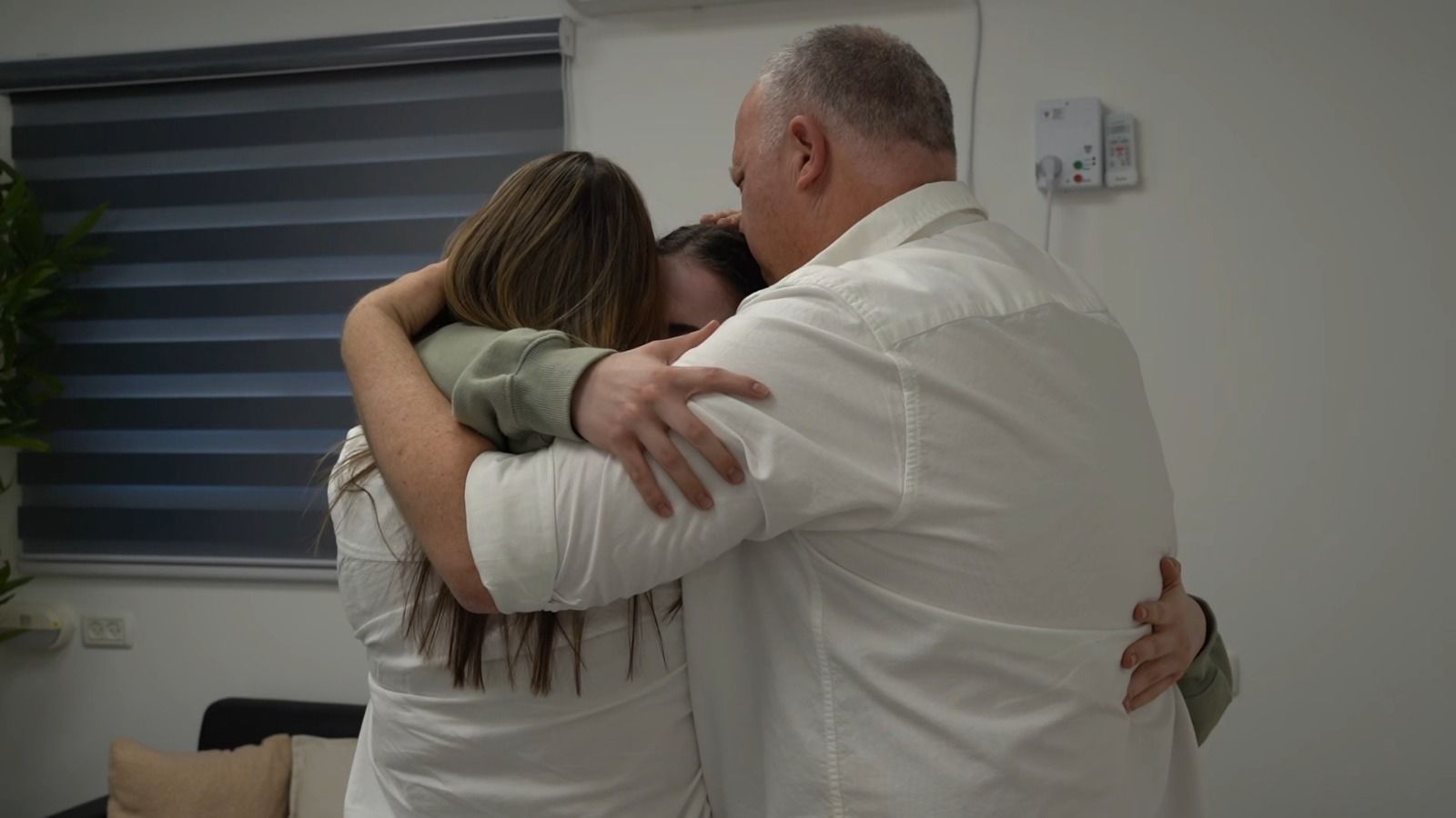 Agam Berger hugs her parents