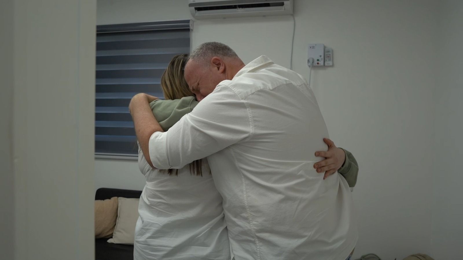 Agam Berger hugs her father