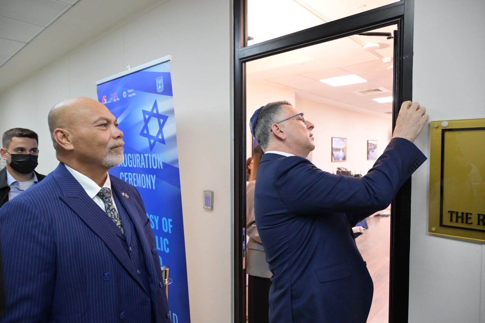 Putting a mezuzah on the new embassy