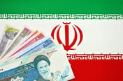 Iranian Rial IRR banknotes from Iran on flag of Islamic Republic of Iran close up