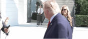 Trump's spokeswoman behind him, today