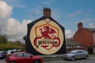 Wrexham, Wales - A "Welcome to Wrexham" mural on the exterior wall of a row of houses,