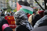 Pro-Palestinian protester wearing a keffiyeh at demonstration on Broadway outside of Columbia University