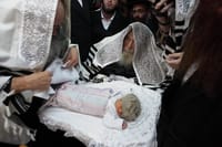 Illustration: The rebbe of Sadigora takes part at a circumcision ceremony in the city of Bnei Brak