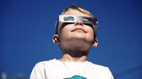 Child watching an eclipse