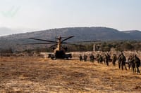 Carrying wounded students and teachers towards waiting IDF helicopters