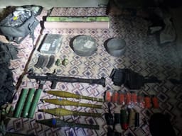 Weapons discovered in underground warehouse.