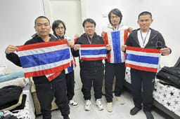 Thai hostages who were freed from Hamas captivity, from left to right, Surasak Lumnau, Sathian Suwannakham, Bannawat Saethao, Watchara Sriaoun and Pongsak Thaenna, hold the Thailand flag