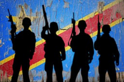 Flag of Congo Democratic painted on the cracked wall with soldier shadow. 