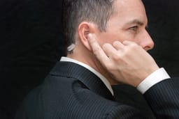 Close-up of a secret service agent listening to his earpiece