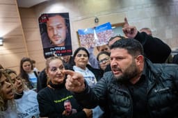 MK Almog Cohen reacts next to families of Israelis who were murdered by Hamas terrorists at the Nova festival at the Knesset, the Israeli parliament in Jerusalem on February 10, 2025. 