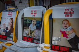 Pictures of Shiri Bibas and her children Kfir and Ariel who are held hostage in Hamas captivity hang outside the protest tent calling for the release of Israeli hostages in the Gaza Strip, outside the Prime Minister's residence in Jerusalem, February 19, 2025