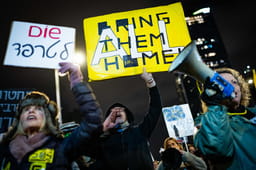 Demonstrators protest for the release of Israelis held hostage in the Gaza Strip, outside Hakirya Base in Tel Aviv, February 22, 2025
