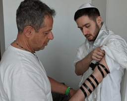 Omer Shem Tov donning tefillin