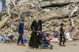 Palestinians among the ruins in Gaza.