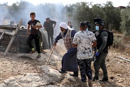Israeli security forces argue with Palestinians as they arrive to demolish a house that was built without a permit in Yatta, Judea and Samaria