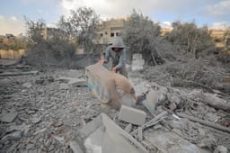 Palestinians at the scene of an Israeli airstrike in Gaza City, on March 18, 2025