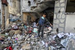 Palestinians at the scene of an Israeli airstrike in Khan Yunis, on March 18, 2025. 