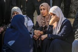 Palestinians mourn the death of Palestinians killed in an Israeli air strike outside the Nasser Hospital in Khan Yunis, in the southern Gaza Strip, March 18, 2025. 