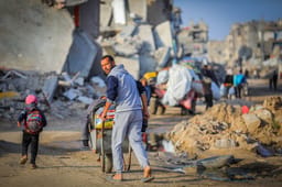 Palestinians seen with their belongings after fleeing from their homes in the Al-Maghraqa area in the central Gaza Strip, on Marsh 18, 2025. 