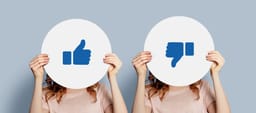 Women holding poster with thumbs up and thumbs down