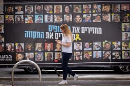 Wall showing pictures of hostages.