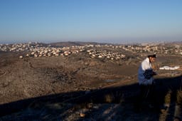 Young Jewish men seen outside the synagogue on the morning of the second day into the evacuation of the illegal outpost of Amona