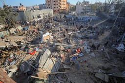 Palestinians at the site of an Israeli airstrike, in the Al-Bureij camp, in the Gaza Strip, May 7, 2025. 