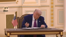 Donald Trump signing in Riyadh